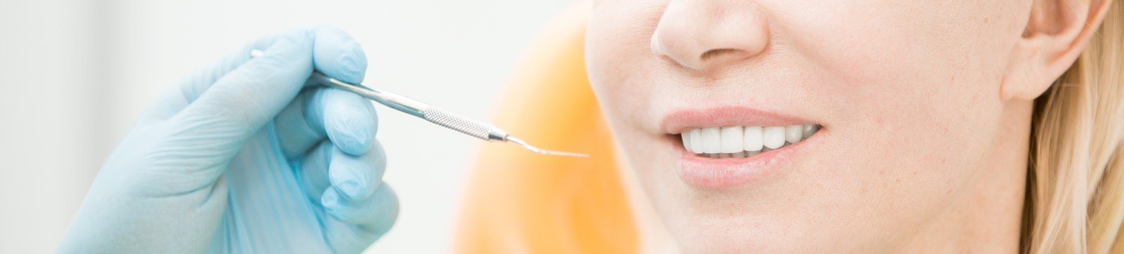 Dentist showing a patient a dental crown shade during a restorative visit in Orlando