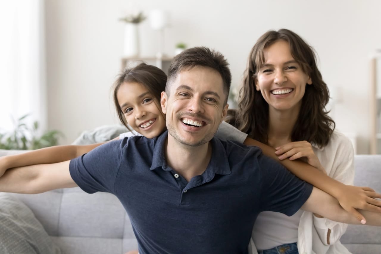 A happy family smiling together at University Dental Group in Orlando