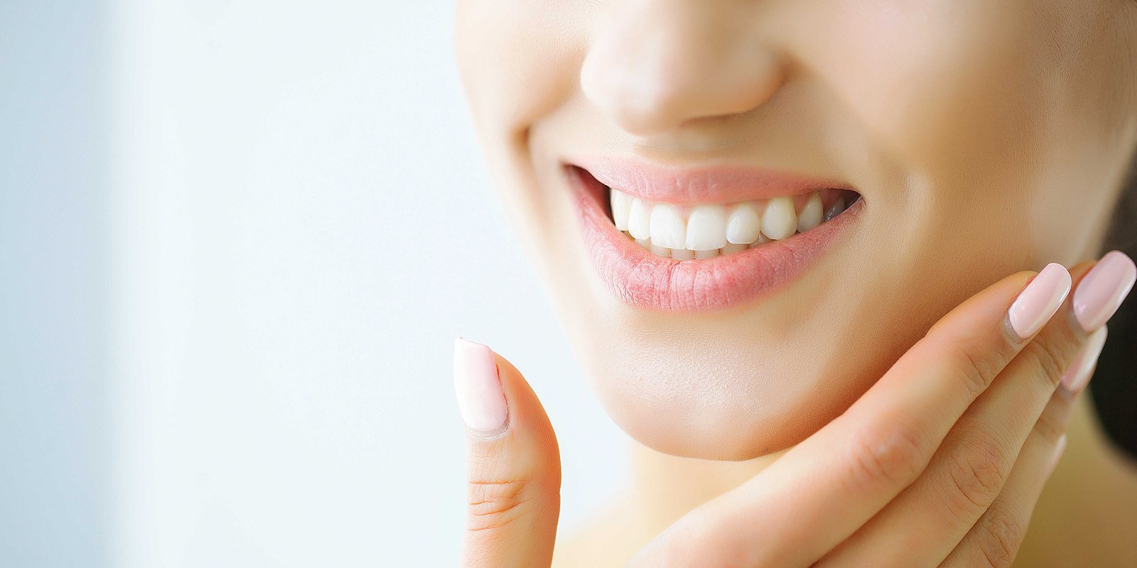 Patient resting a hand against her jaw after a tooth extraction at an Orlando dental office